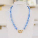Bright light blue beaded necklace with a gold clasp.