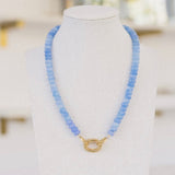 Bright light blue beaded necklace with a gold clasp.