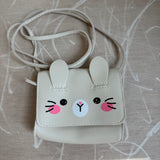 Picture of a little girl's purse. Purse is made to look like a sparkly cream colored bunny face.