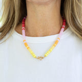 Picture of a brightly colored bead necklace in red, pink and yellows.