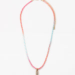 Necklace with colorful cord and gold rectangle pendant on a white background
