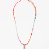 Necklace with colorful cord and gold rectangle pendant on a white background