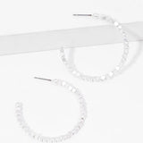 Picture of a set of white bead hoop earrings.