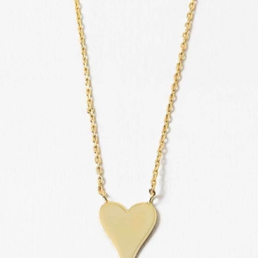 Gold heart-shaped pendant on a delicate gold necklace on a white background