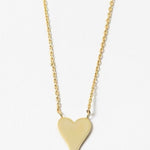 Gold heart-shaped pendant on a delicate gold necklace on a white background