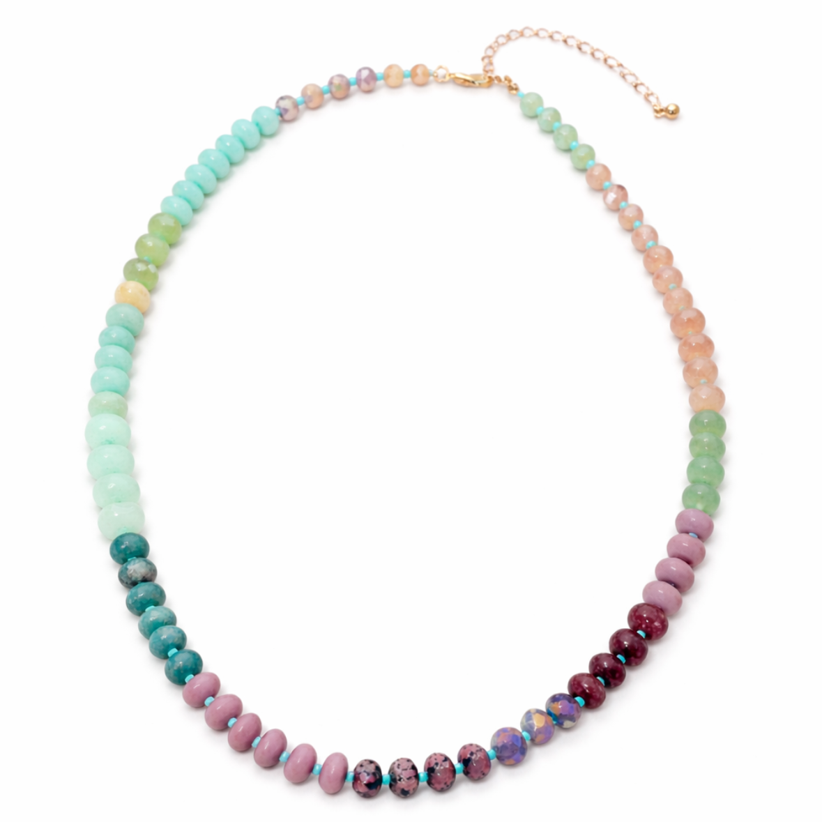 Multicolored green, pink and coral beaded necklace on a white background