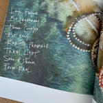 Picture of book page showing aerial beach shot with beaded jewelry overlayed and a poem written.