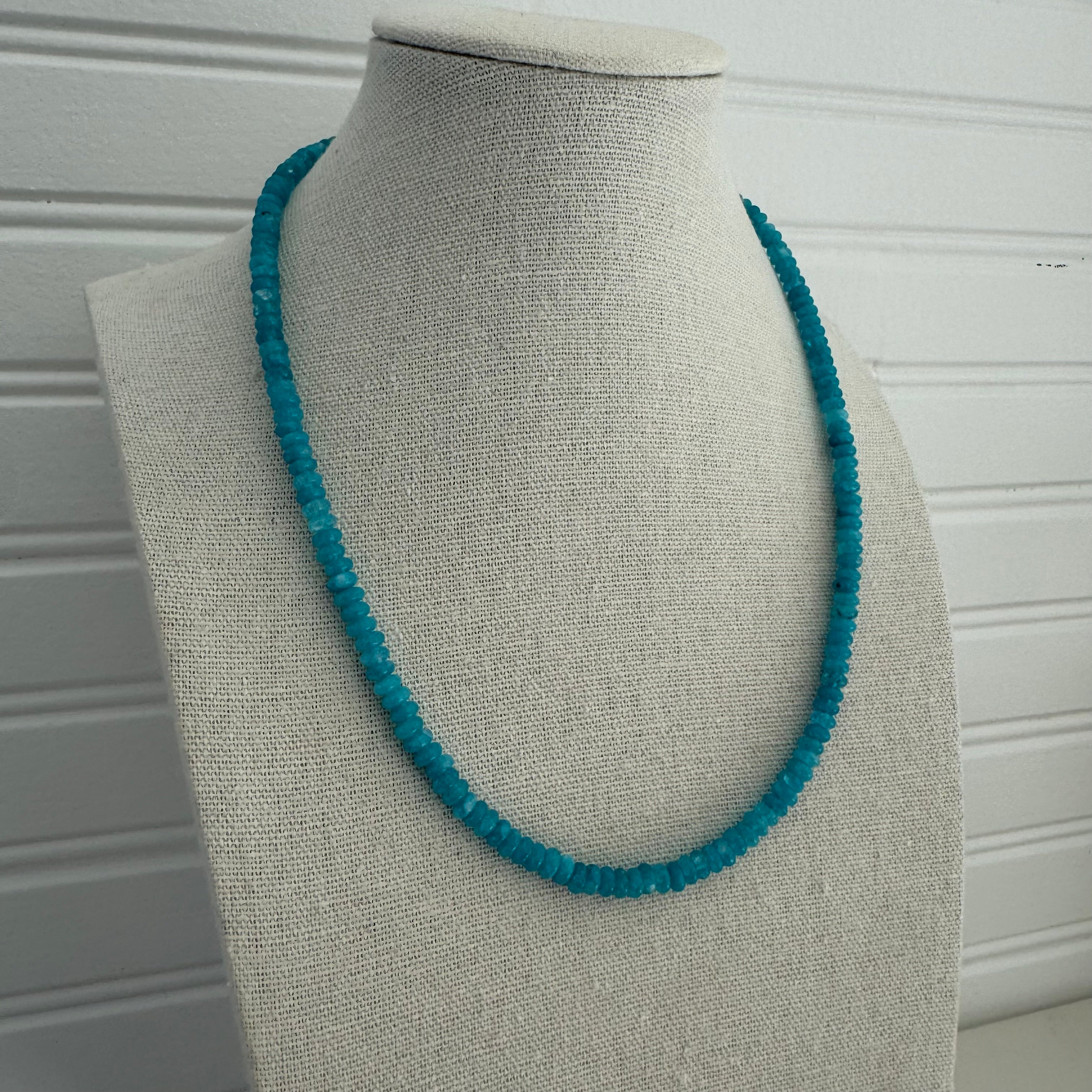 Picture of a necklace made of small turquoise beads,