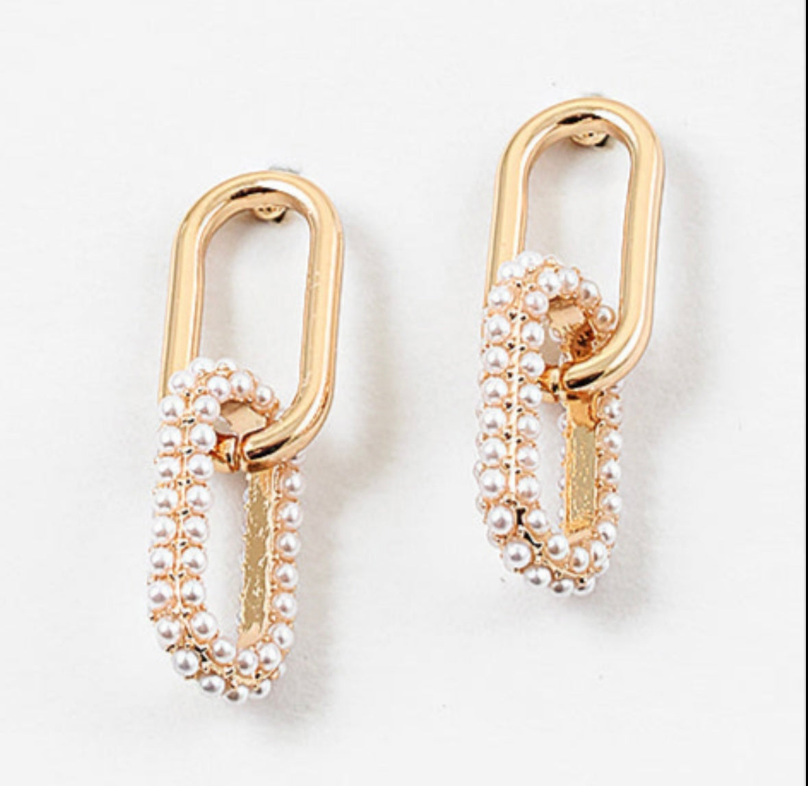 Set of gold chain link earrings. Bottom link is covered in pearls.