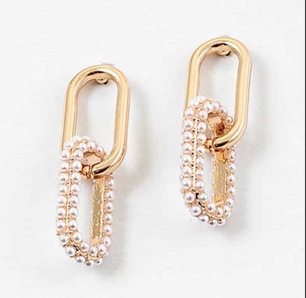 Set of gold chain link earrings. Bottom link is covered in pearls.