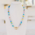 Beautiful multi-colored necklace of blue, white, yellow and pinks with a gold clasp.