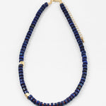 Navy bead necklace with two gold accent spacers beads.