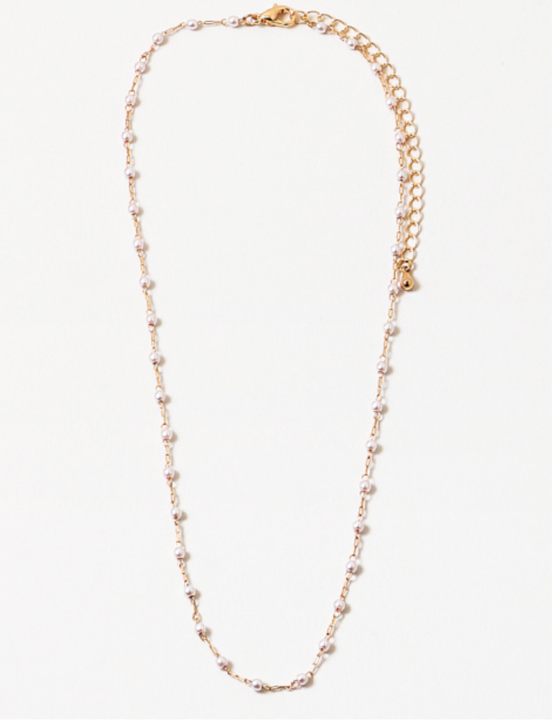 Dainty gold chain necklace with freshwater pearls on a white background