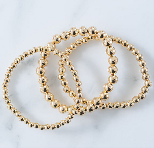 Picture of set of three gold bead bracelets in varying bead sizes.