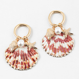 Set of half shell earrings with gold tipped edges. Earrings hang from small gold hoops with three small pendants dangling from them. One is a small golden conch, a golden starfish and a small fresh water pearl.