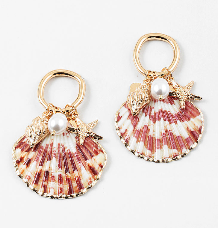 Set of half shell earrings with gold tipped edges. Earrings hang from small gold hoops with three small pendants dangling from them. One is a small golden conch, a golden starfish and a small fresh water pearl.