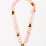 Beaded necklace with pink, orange, and brown beads with a gold clasp on a white background