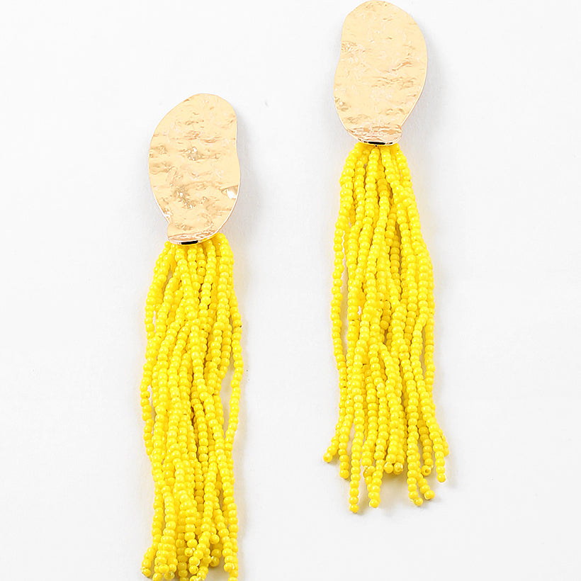 Picture of gold hammered ovals with many  strands of yellow seed beads.