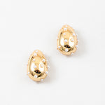 Picture of chunky gold teardrop earrings with small pearls inlaid all over.