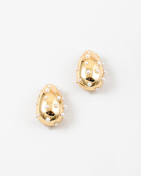 Picture of chunky gold teardrop earrings with small pearls inlaid all over.