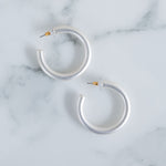 Picture of white silver hoop earrings.