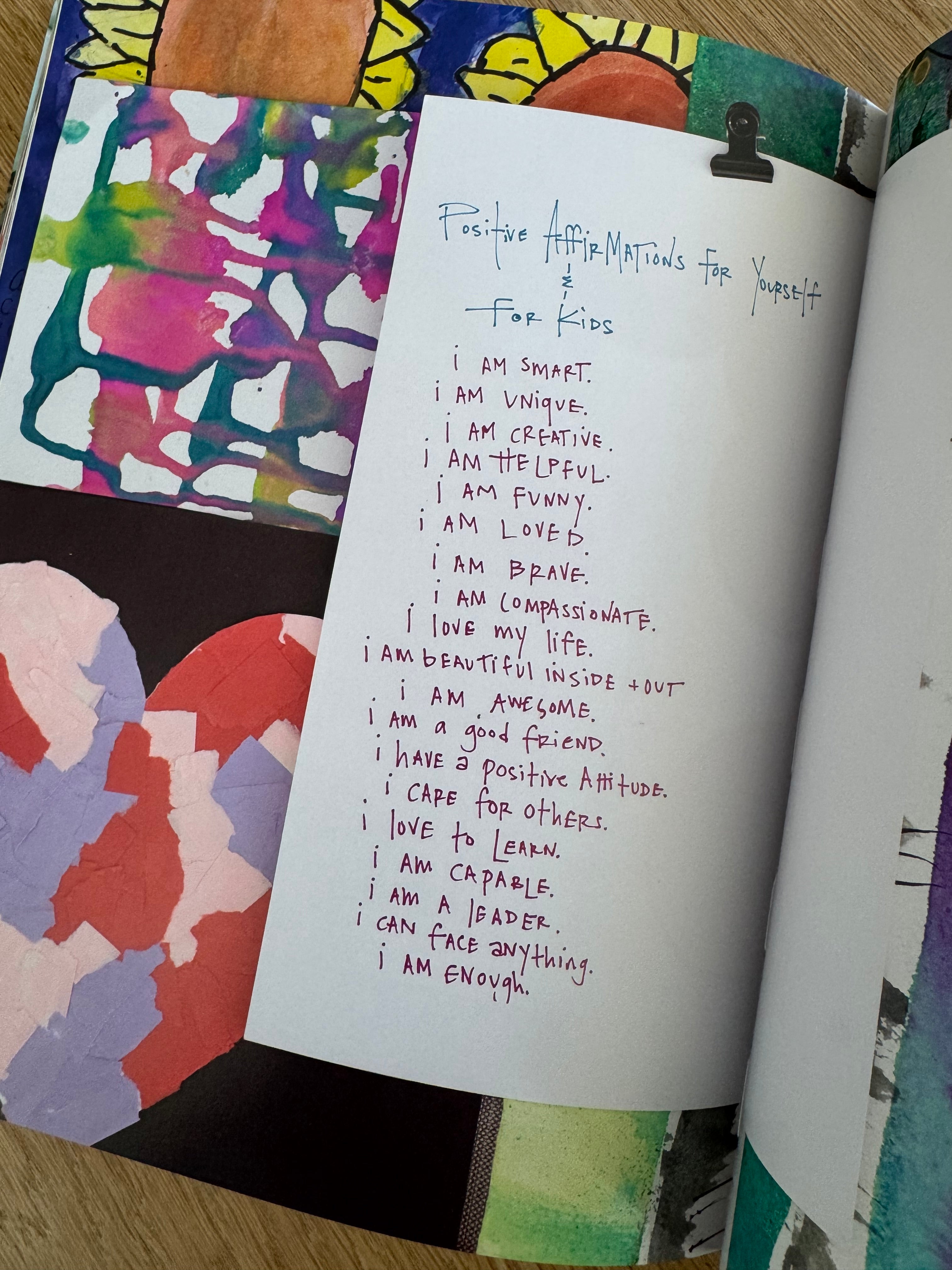 Open notebook with handwritten text on a colorful, patterned surface