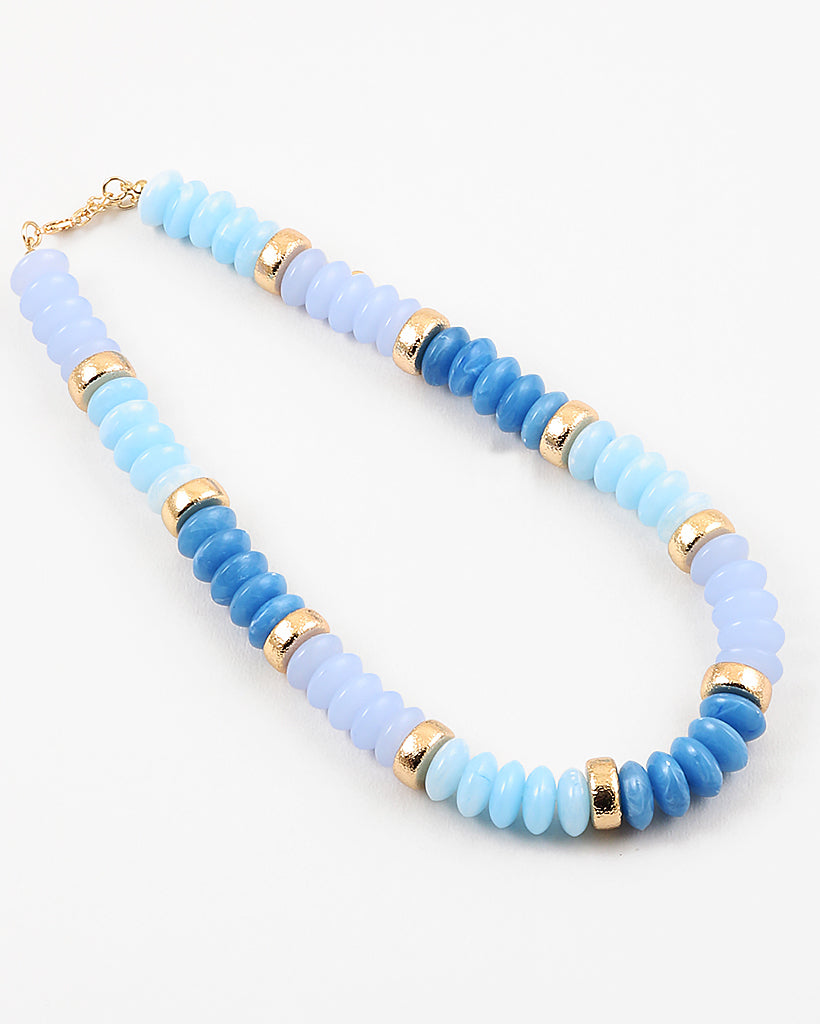 Chunky bead necklace in hues of opaque blues and gold spacer beads.