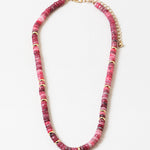 Picture of marbled rose and pink beaded necklace with gold accent beads interspersed through out.
