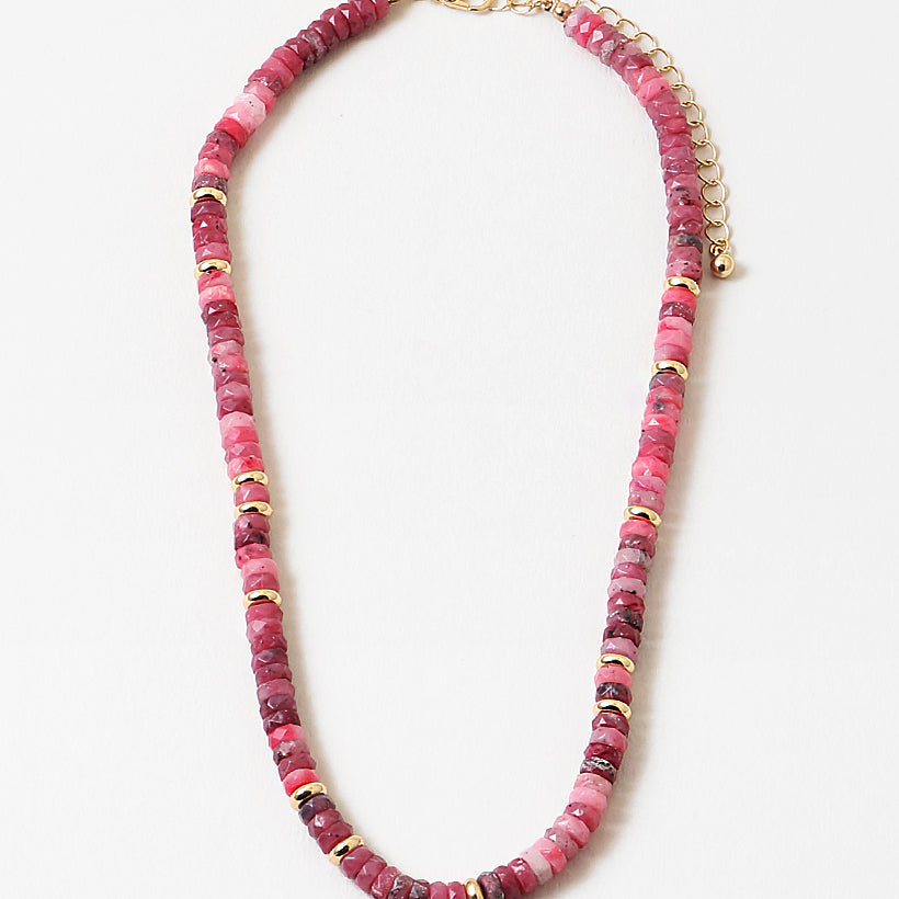 Picture of marbled rose and pink beaded necklace with gold accent beads interspersed through out.