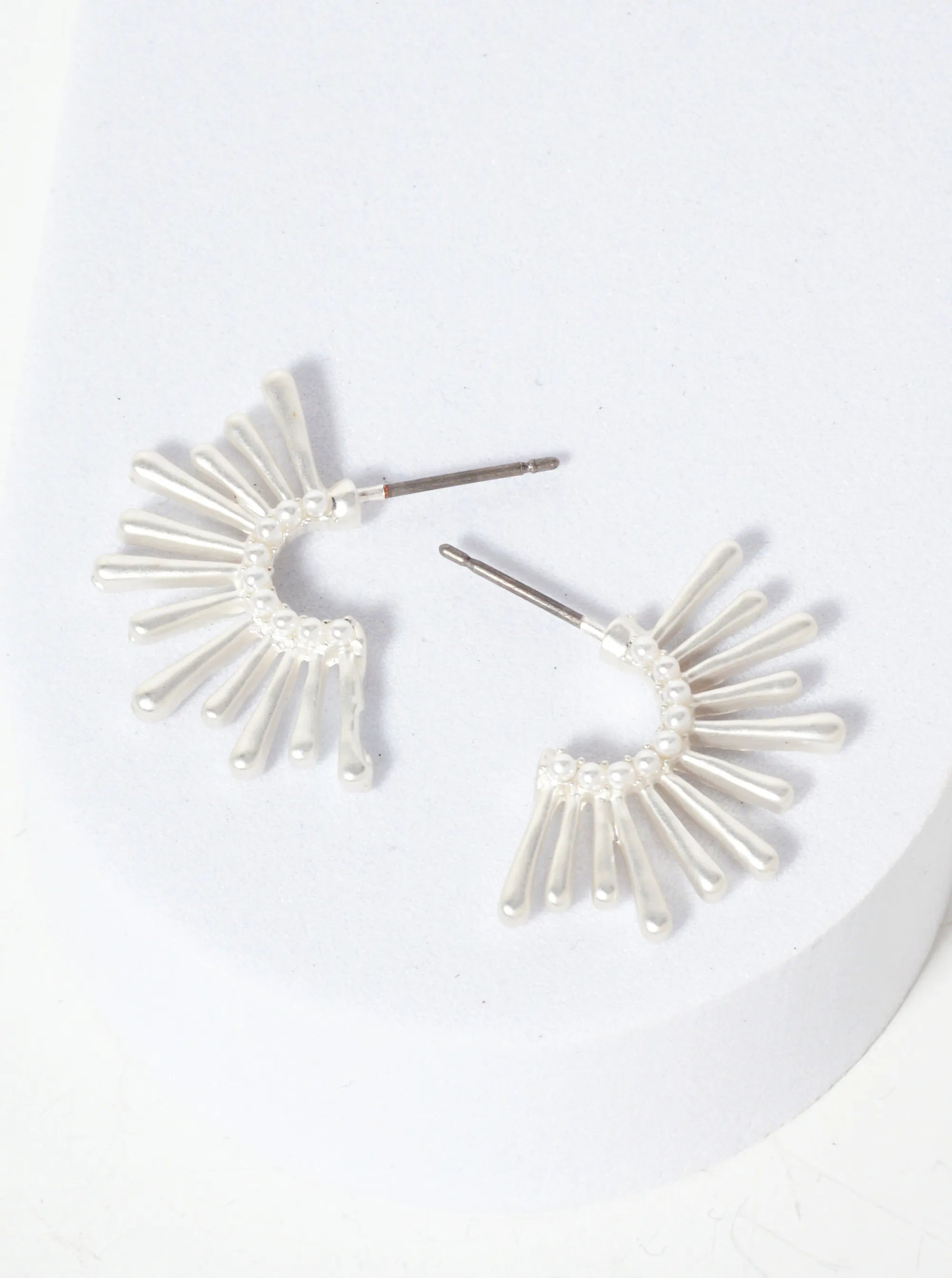 Set of silver starburst hoops.