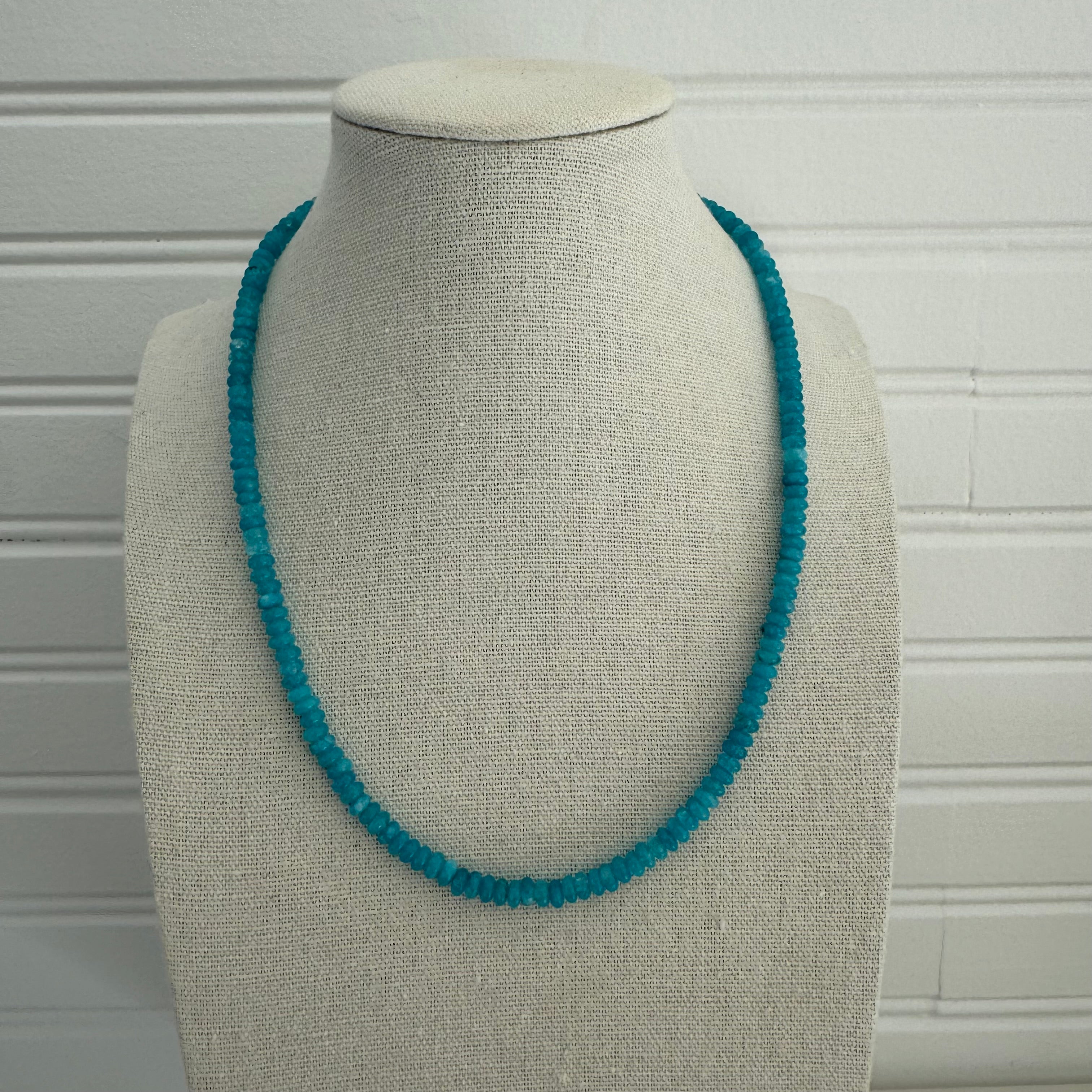 Picture of a necklace made of small turquoise beads.