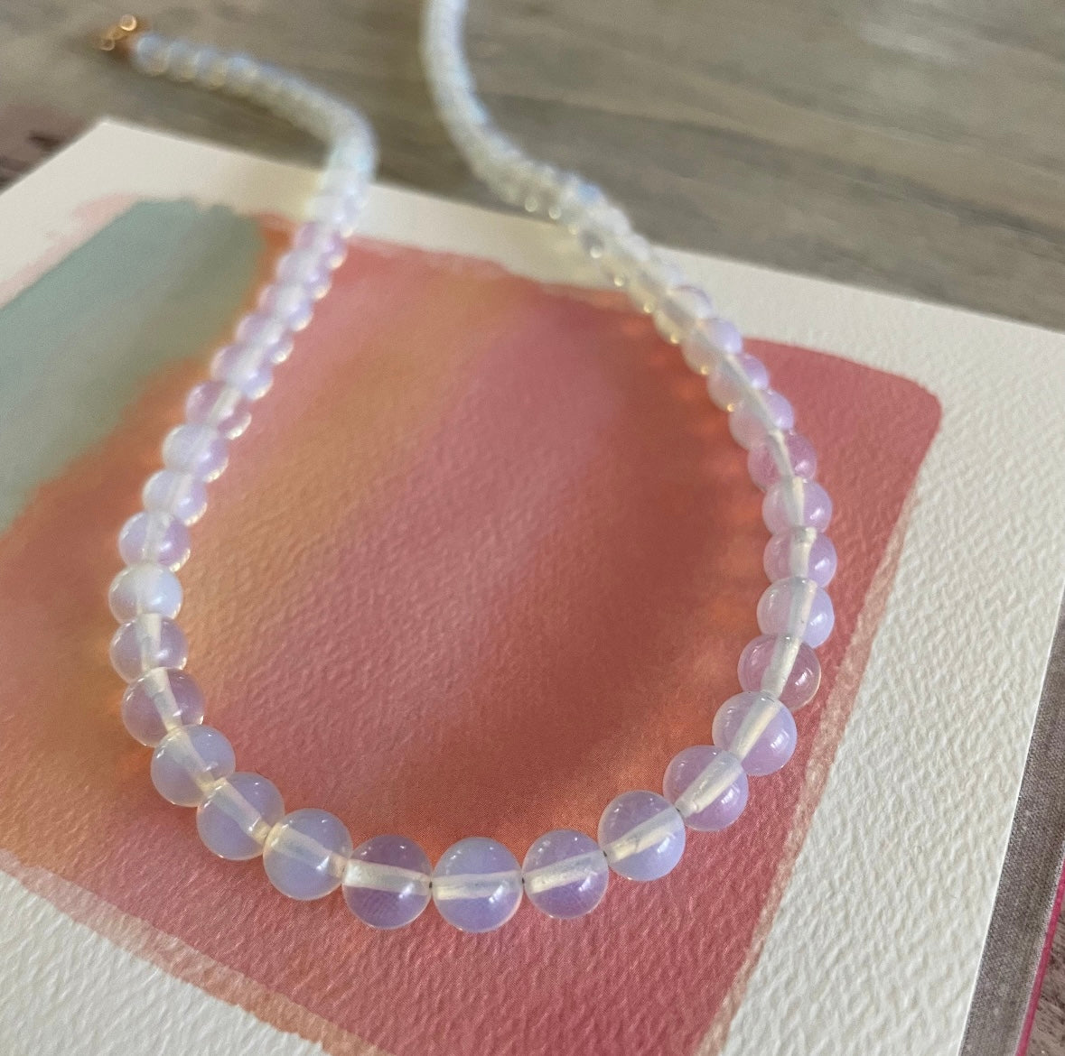 Necklace with clear beads on a textured surface