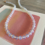 Necklace with clear beads on a textured surface