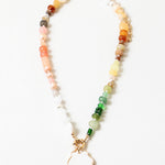 Multicolor bead necklace with a large white enamel shell pendant.