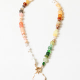 Multicolor bead necklace with a large white enamel shell pendant.