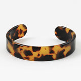 Tortoiseshell patterned cuff bracelet on a white background