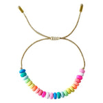 Adjustable woven bracelet with bright colored beads in pinks, yellows, greens and blues.