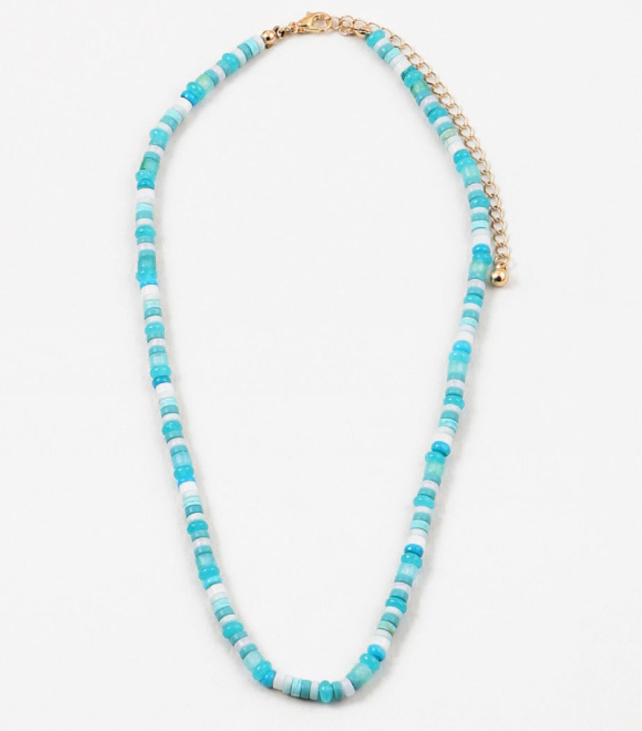 Necklace with blue and white beads on a white background