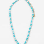 Necklace with blue and white beads on a white background