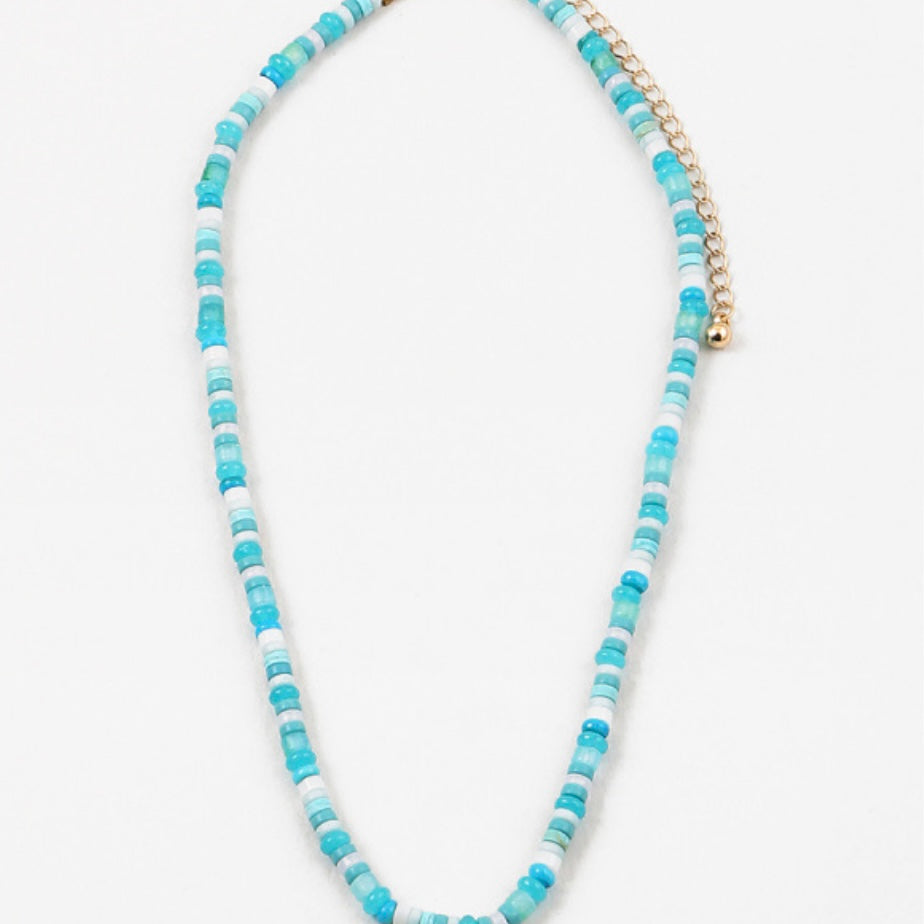 Necklace with blue and white beads on a white background