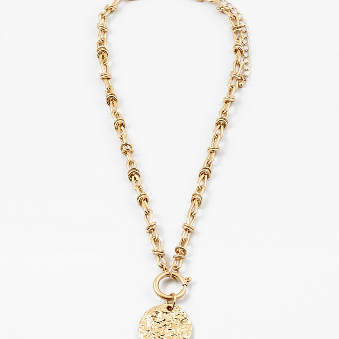 Gold toggle chain necklace with a large hammered disc pendant.
