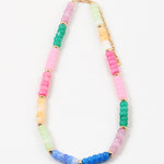 Picture of a multicolored beaded necklace in pinks, blues, greens and yellows with gold accent beads every 5th bead.