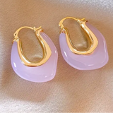 Picture of opaque rose colored hoops with gold interior.