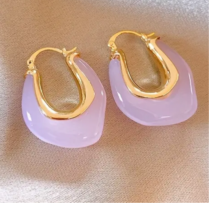 Picture of opaque rose colored hoops with gold interior.