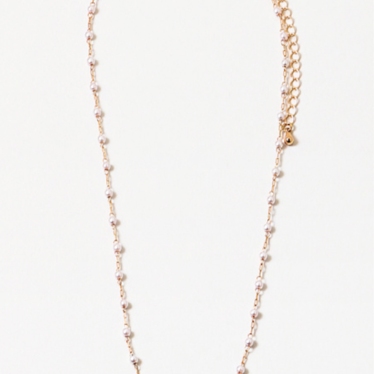 A necklace with small pearls and gold delicate chain links, with an extender chain, displayed against a white background.
