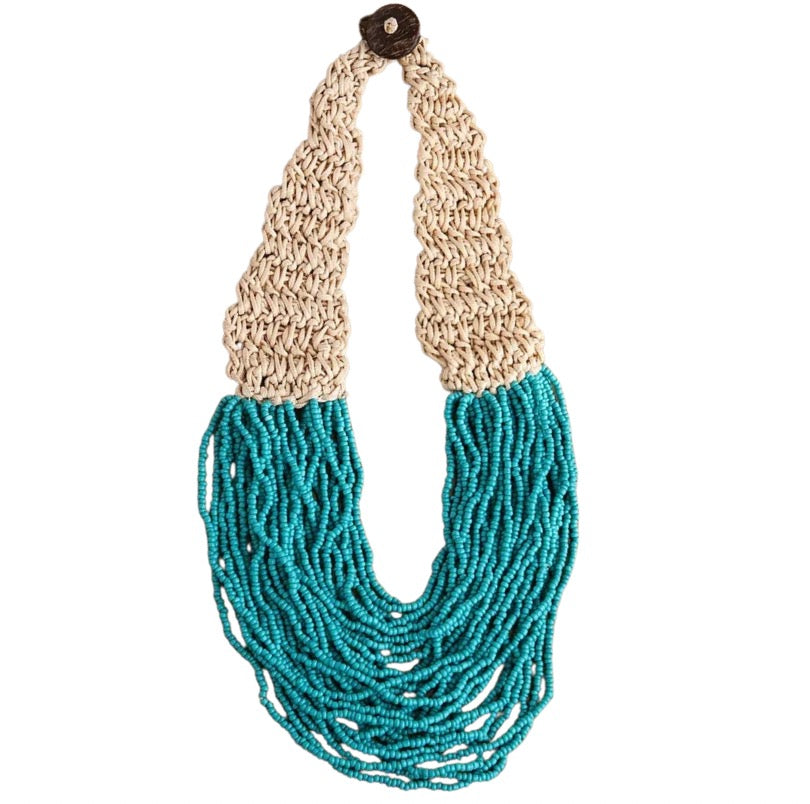 Necklace with beige braided top and many strands of turquoise beads on a white background