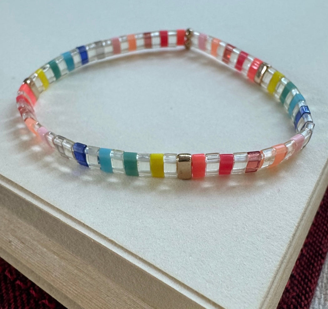 Colorful beaded bracelet on a white surface