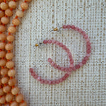 Large pink beaded hoop earrings