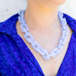 Woman wearing a light purple chunky chain necklace around her neck