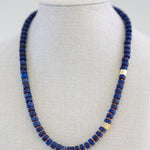 Necklace with blue beads on a mannequin against a white background